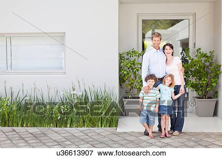 Family smiling outside front door View Large Photo Image Stock Photo - Family smiling outside front door. Fotosearch