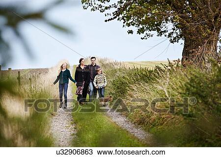 Family walking together on rural road View Large Photo Image Stock Image - Family walking together on rural road. Fotosearch