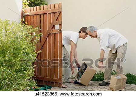 Father and son dropping box outdoors View Large Photo Image Stock Photography - Father and son dropping box outdoors. Fotosearch
