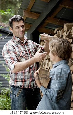 Father and son getting firewood outdoors View Large Photo Image Stock Image - Father and son getting firewood outdoors. Fotosearch