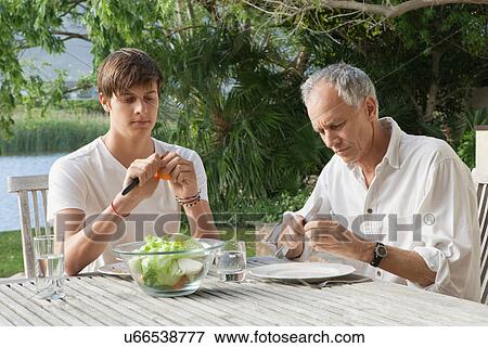 Father and son making salad outdoors View Large Photo Image Stock Photo - Father and son making salad outdoors. Fotosearch