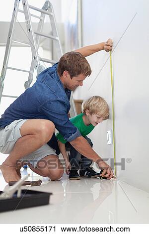 Father and son measuring wall View Large Photo Image Stock Image - Father and son measuring wall. Fotosearch