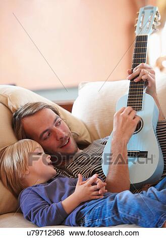 Father and son playing ukulele View Large Photo Image Stock Photo - Father and son playing ukulele. Fotosearch
