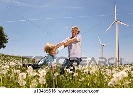 Stock Photograph - Father and son with wind turbines. Fotosearch