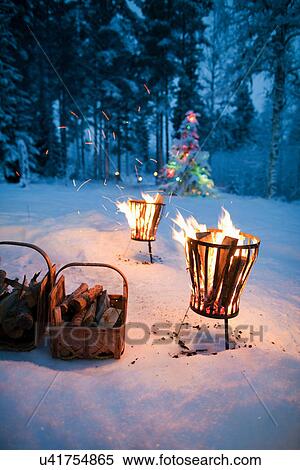 Stock Photography - Fires in pits in snowy field. Fotosearch
