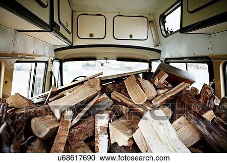 Stock Image - Firewood piled in van. Fotosearch