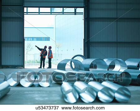 Foreman and apprentice in doorway in factory of building site View Large Photo Image Stock Photo - Foreman and apprentice in doorway in factory of building site. Fotosearch