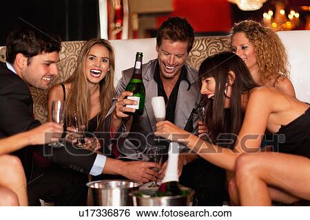 Friends drinking champagne in club View Large Photo Image Stock Photograph - Friends drinking champagne in club. Fotosearch