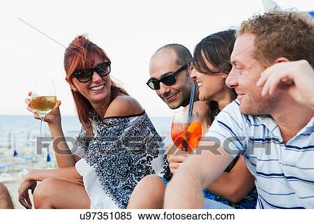 Friends drinking together outdoors View Large Photo Image Stock Photography - Friends drinking together outdoors. Fotosearch