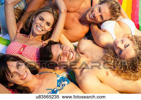 Stock Photography - Friends relaxing together on blankets. Fotosearch