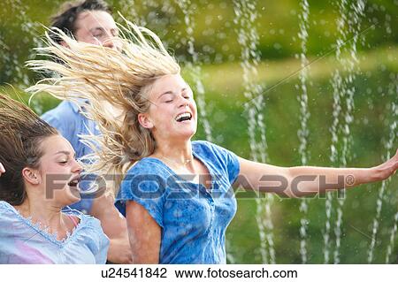 Friends running in sprinkler View Large Photo Image Stock Image - Friends running in sprinkler. Fotosearch