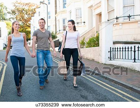 Friends walking on village street View Large Photo Image Stock Photo - Friends walking on village street. Fotosearch