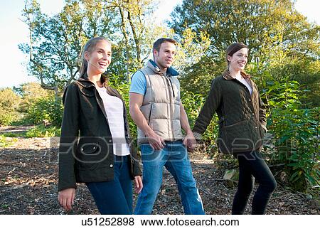 Stock Photo - Friends walking together in park. Fotosearch