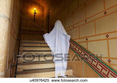 Stock Photography - Ghost floating on ornate stairs. Fotosearch