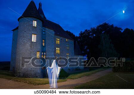 Ghost floating outside stone house View Large Photo Image Picture - Ghost floating outside stone house. Fotosearch