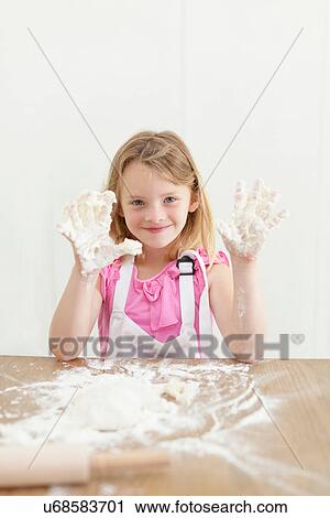 Girl baking with sticky hands in kitchen View Large Photo Image Stock Image - Girl baking with sticky hands in kitchen. Fotosearch