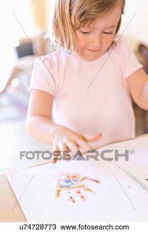 Girl finger-painting in notebook View Large Photo Image Stock Image - Girl finger-painting in notebook. Fotosearch
