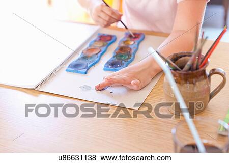 Girl finger-painting with watercolors View Large Photo Image Stock Photo - Girl finger-painting with watercolors. Fotosearch