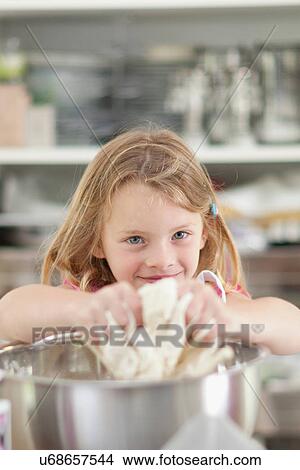 Girl kneading dough in kitchen View Large Photo Image Picture - Girl kneading dough in kitchen. Fotosearch