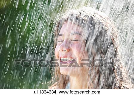 Picture - Girl playing in rain. Fotosearch