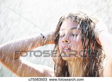 Girl playing in rain View Large Photo Image Stock Image - Girl playing in rain. Fotosearch