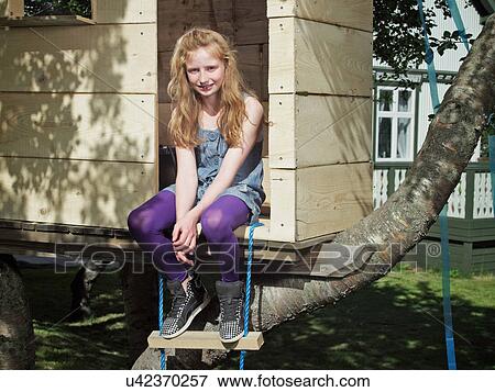 Girl playing in treehouse View Large Photo Image Stock Photo - Girl playing in treehouse. Fotosearch