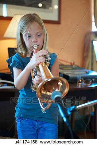 Girl playing trumpet into microphone View Large Photo Image Stock Photo - Girl playing trumpet into microphone. Fotosearch