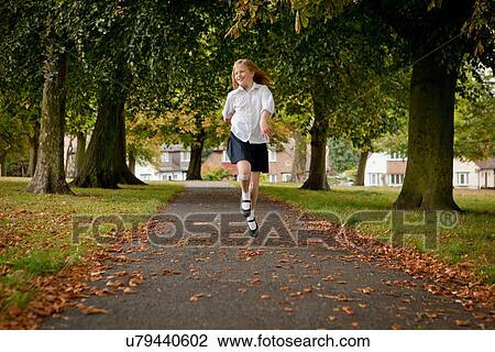 Girl skipping on road in park View Large Photo Image Stock Image - Girl skipping on road in park. Fotosearch