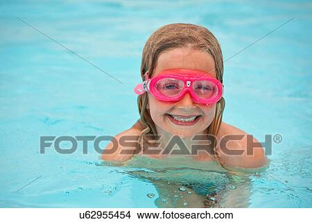 Picture - Girl wearing goggles in swimming pool. Fotosearch
