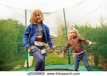 Girls playing on trampoline View Large Photo Image Stock Photography - Girls playing on trampoline. Fotosearch