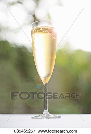 Stock Photo - Glass of champagne outdoors. Fotosearch