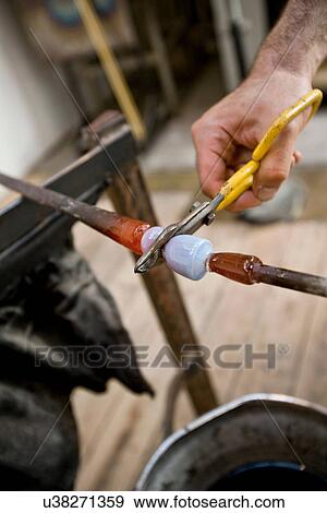 Glassblower snipping hot glass View Large Photo Image Stock Photo - Glassblower snipping hot glass. Fotosearch