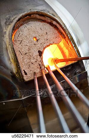 Glassblowers heating glass in kiln View Large Photo Image Stock Image - Glassblowers heating glass in kiln. Fotosearch