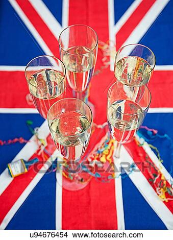 Picture - Glasses of champagne on Union Jack. Fotosearch
