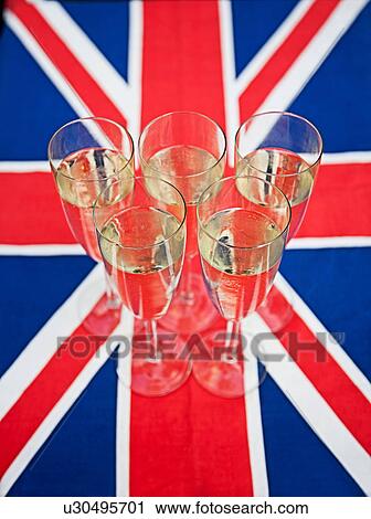 Stock Image - Glasses of champagne on Union Jack. Fotosearch