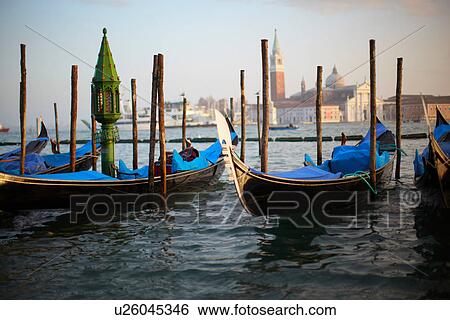 Gondolas docked at urban pier View Large Photo Image Stock Photograph - Gondolas docked at urban pier. Fotosearch