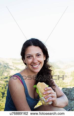 Hiker eating sandwich on hill View Large Photo Image Stock Image - Hiker eating sandwich on hill. Fotosearch
