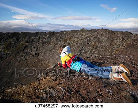 Hiker overlooking rocky canyon View Large Photo Image Stock Photo - Hiker overlooking rocky canyon. Fotosearch