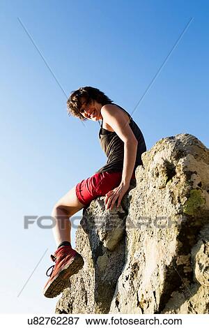 Hiker resting on rocks View Large Photo Image Stock Photo - Hiker resting on rocks. Fotosearch