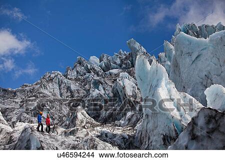 Hikers admiring glacial landscape View Large Photo Image Picture - Hikers admiring glacial landscape. Fotosearch
