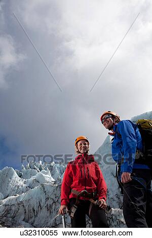 Hikers admiring glacial landscape View Large Photo Image Stock Photography - Hikers admiring glacial landscape. Fotosearch
