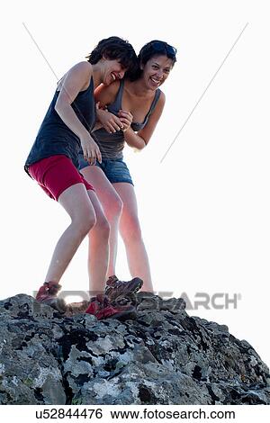 Hikers laughing on rock View Large Photo Image Stock Photograph - Hikers laughing on rock. Fotosearch