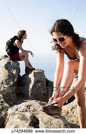 Hikers resting on rock View Large Photo Image Stock Photo - Hikers resting on rock. Fotosearch