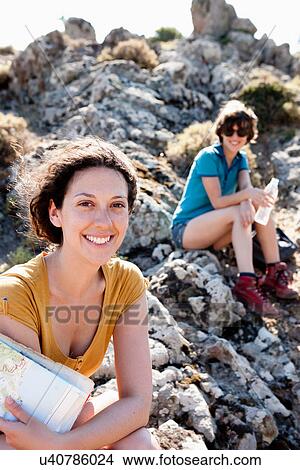 Picture - Hikers resting on rocks. Fotosearch