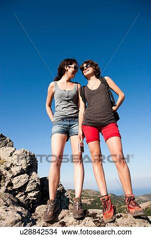 Hikers standing on rocks View Large Photo Image Picture - Hikers standing on rocks. Fotosearch