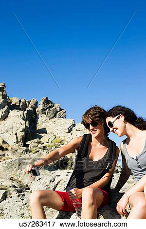 Stock Photo - Hikers taking pictures of themselves. Fotosearch