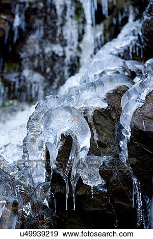 Stock Photo - Icicles dripping over rocks. Fotosearch