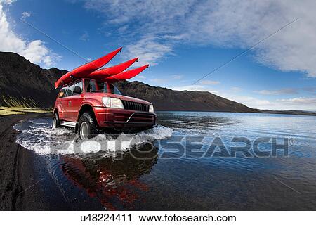 Jeep driving in shallow lake View Large Photo Image Stock Image - Jeep driving in shallow lake. Fotosearch