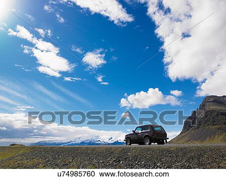 Jeep parked on gravel in rural landscape View Large Photo Image Stock Image - Jeep parked on gravel in rural landscape. Fotosearch