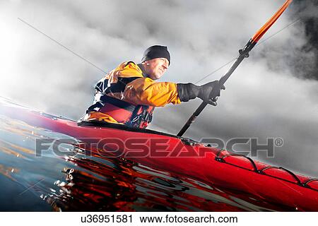 Kayaker paddling in water View Large Photo Image Stock Image - Kayaker paddling in water. Fotosearch